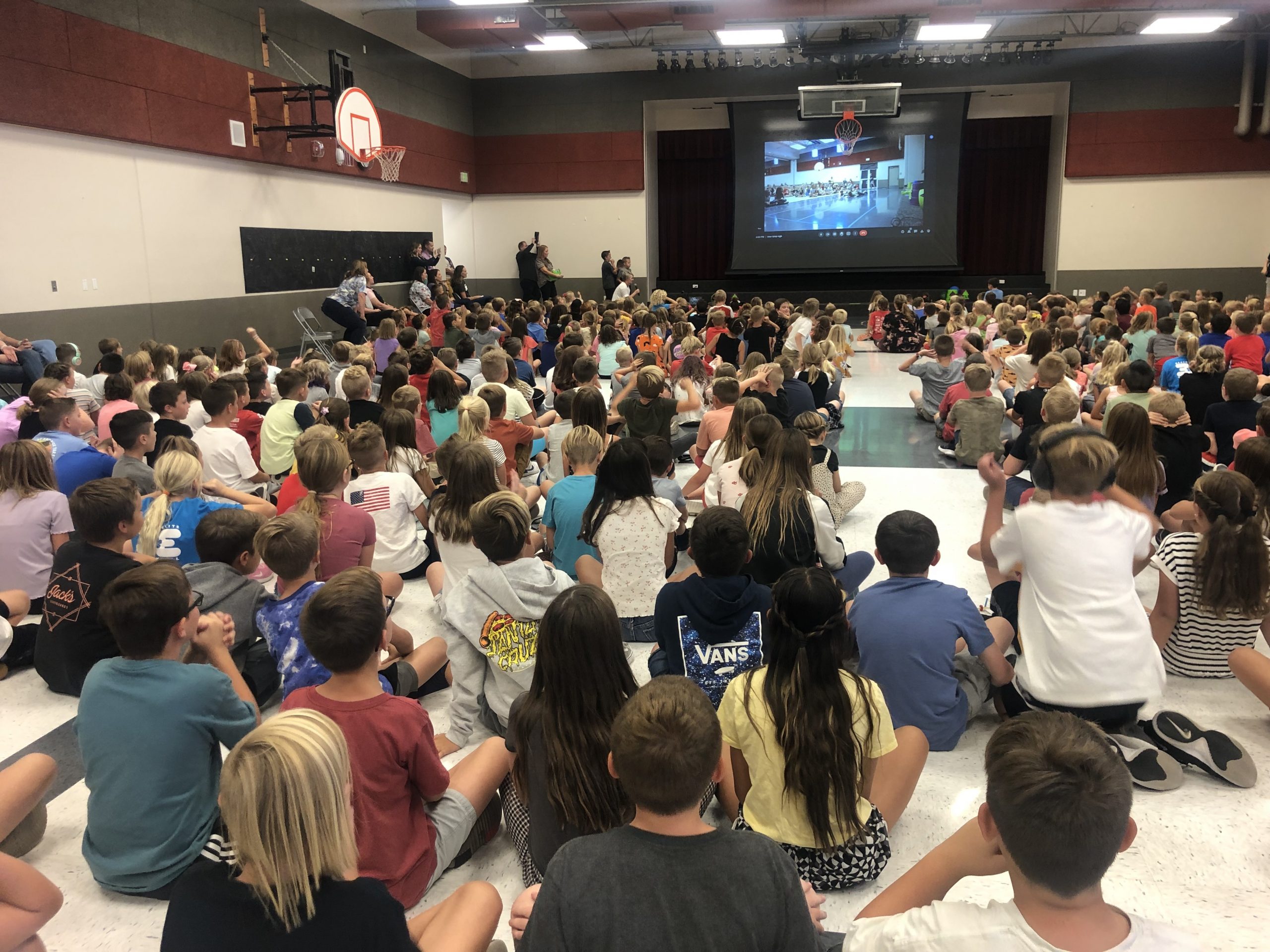 Students watching a stem boat race on a big screen