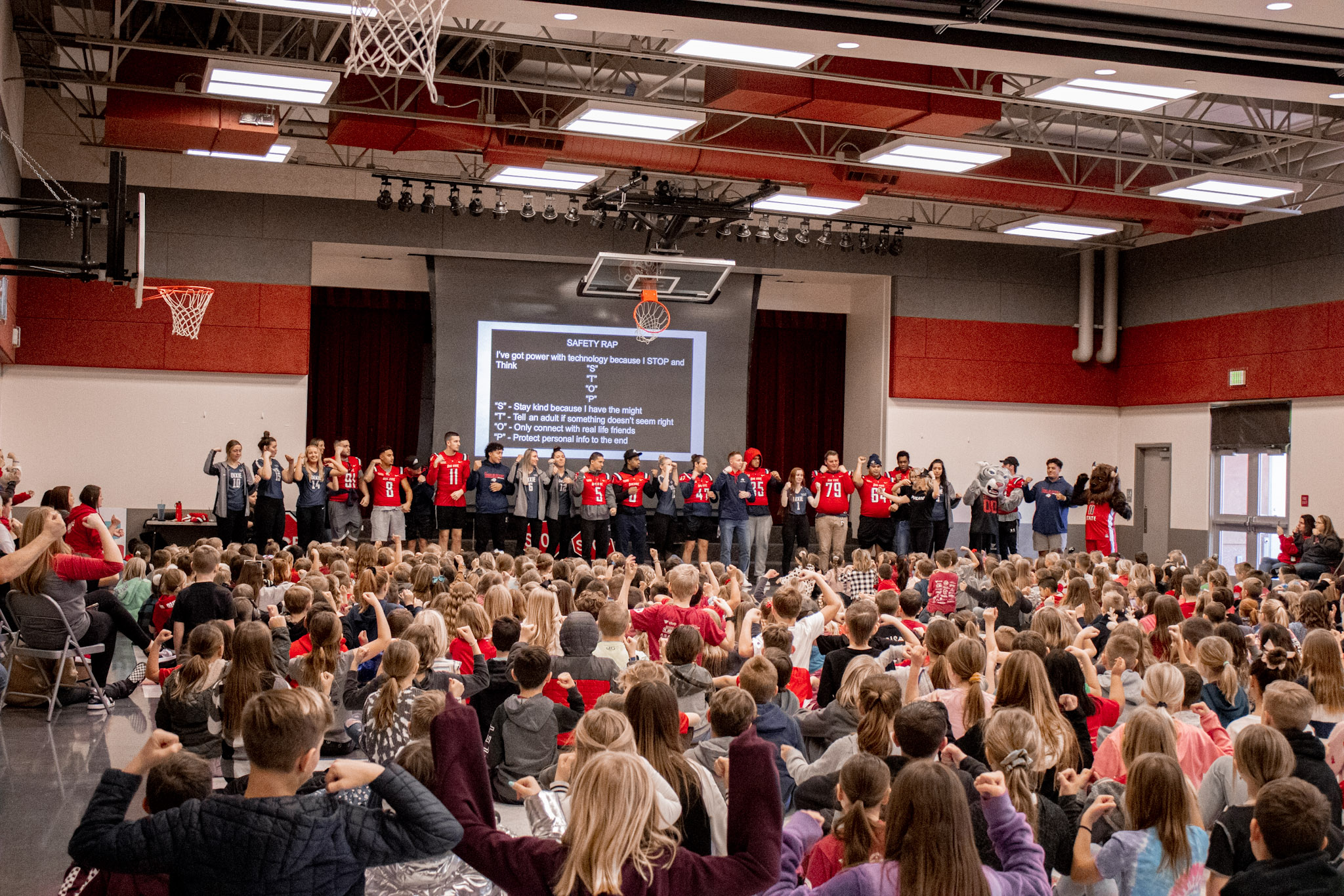 Students in the gym for an assembly with Students from Dixie State. 
